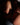Person wearing a brown bra and panties on a dark background