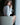 Woman sitting on a chair holding a glass of water indoors.