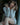 Woman in a white outfit sitting on a chair with a blurred background