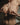 Partial topless body with jewelry and underwear, blurred background