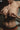 Partial topless body with jewelry and underwear, blurred background