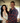 Couple posing together in casual outfits