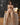 Sex doll sitting on a table with a dark background
