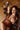 Highly realistic sex doll in brown dress on a sofa.