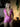 Woman wearing a pink polka dot outfit in a dimly lit room.