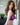 Person wearing a purple lace lingerie set with 'NORMAN' branding.