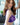 Woman wearing a purple lace lingerie set with a blurred background
