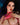 Sex doll with dark hair and red lipstick against a blurred background