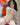Sex doll with a realistic appearance in a room with flowers and a window.
