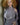 Mannequin wearing a gray ribbed sweater with cut-out shoulders against a neutral background