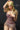 A highly realistic beige sex doll with long blonde hair, posed in a pink dress.