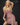 A highly realistic beige sex doll with long blonde hair, posed in a pink dress. The doll has a lifelike appearance with detailed facial features and a flexible skeleton, designed for versatile posing.