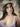 The image shows a highly realistic sex doll with a brown hat.