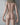 Naked person standing against a neutral background with 'Nudist' branding.