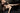 Premium sex doll in lingerie lying on chair with black background
