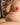 Partial view of a nude figure with a colorful patterned background