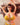 A realistic sex doll with a yellow bikini, long brown hair, and large breasts.