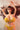 A realistic sex doll with a yellow bikini, long brown hair, and large breasts.