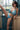 Woman in a blue bikini posing indoors with a window in the background