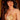 Woman wearing a gold bikini with a blurred background