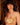 Woman wearing a gold bikini with a blurred background