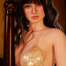 Woman wearing a gold bikini with a blurred background