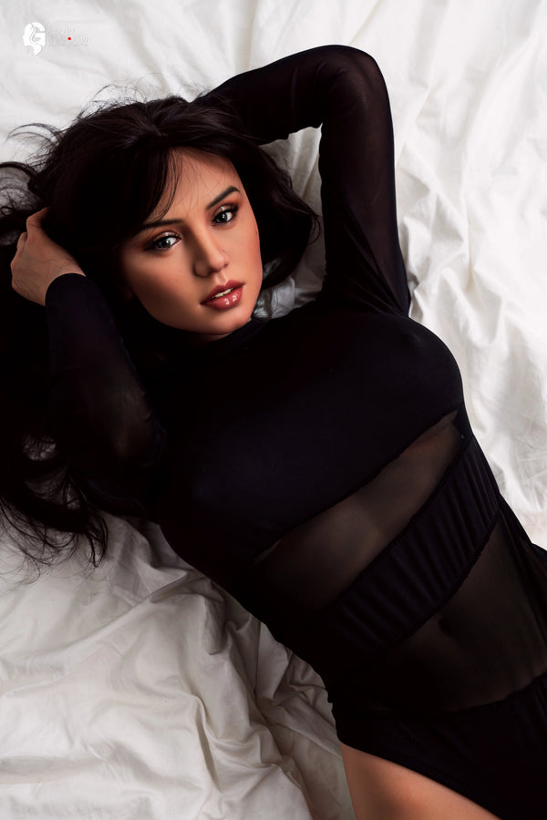 Woman in a black outfit lying on a white textured surface