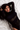 Woman in a black outfit lying on a white surface