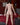 Naked person standing in a bedroom with red bedding and a map on the wall.