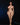 Naked woman standing against a black background with a green object on the ground.