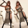 Woman in a hooded dress holding a sword in a studio setting