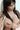 Topless Asian woman with hand covering chest