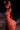 Nude figure with devilish features against a dark background