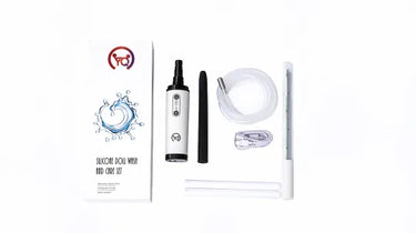 Silicone facial cleansing and face mask set on a white background, including a white and black cylindrical device, black and white applicator wand, clear tubing, a small clear container, two white sticks, and a printed instruction booklet.