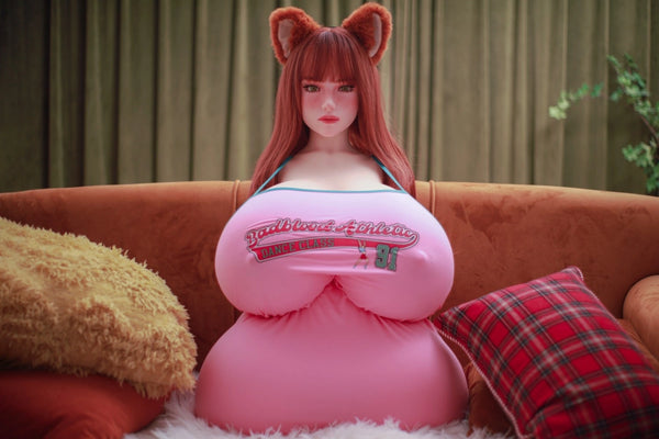Person wearing a large pink inflatable costume with cat ears on a couch.