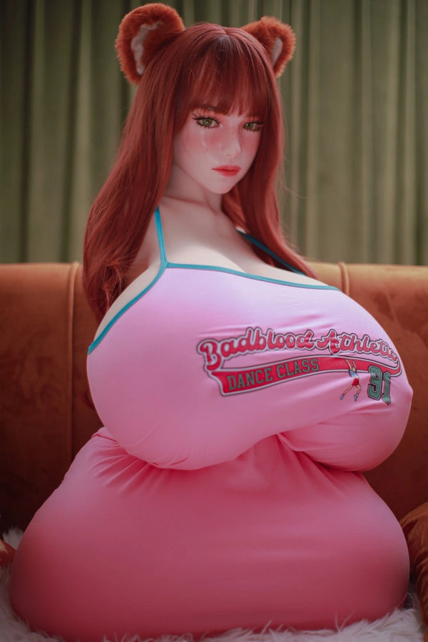 Person wearing a pink dress with a logo, sitting on a couch.