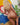 Partial nude figure of a person with blonde hair on a colorful background