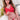 Person wearing a red outfit with a white cross on a white couch.