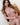 Naked person sitting on a wooden chair with a white background