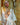 Person wearing a white robe in front of a shower with 'GalaTeardoll' branding.