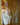 Sex doll in a white satin robe with a blurred background