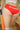 Person wearing red underwear with 'Groceries' text, holding a baseball bat.