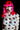 Person with pink hair and polka dot body paint wearing a white bra against a black background