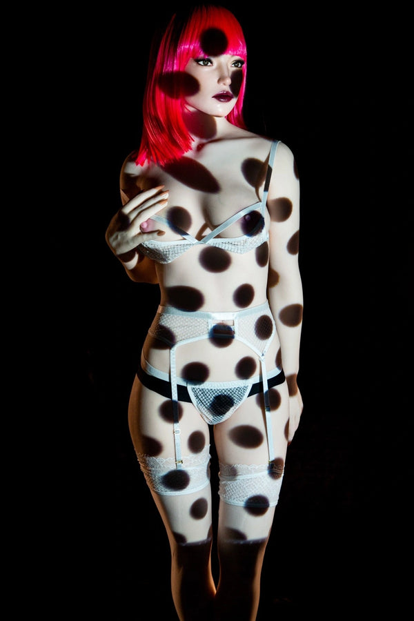 Person wearing a polka dot outfit with a black background