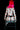 Person with glowing pink hair sitting on a chair with polka dot pattern.