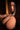 Woman in a dark setting with a focus on her upper body.