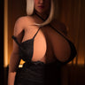 Person wearing a black dress with a deep neckline in a dimly lit setting