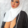 Person wearing a white hijab and black outfit against a neutral background