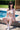 Woman in a bikini sitting by a pool