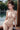 Woman sitting by a window with a blurred outdoor background